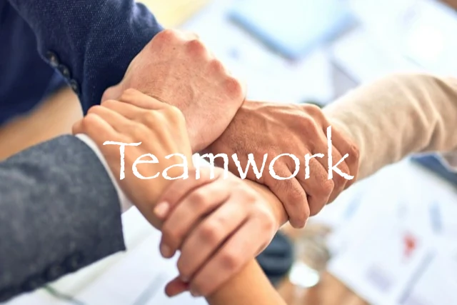 Cross of four arms with an artificial 'Teamwork' text placed over the image